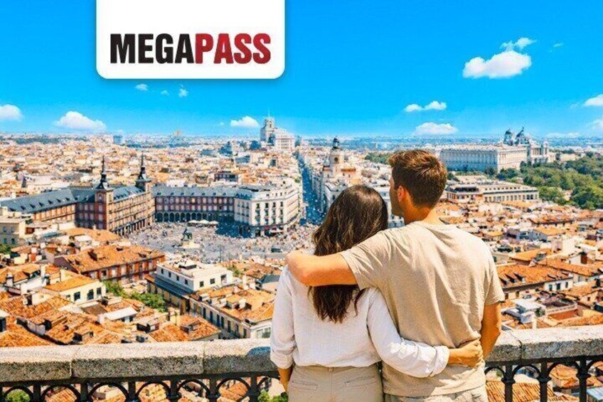 A couple overlooking a cityscape with historic architecture and a clear sky. 1