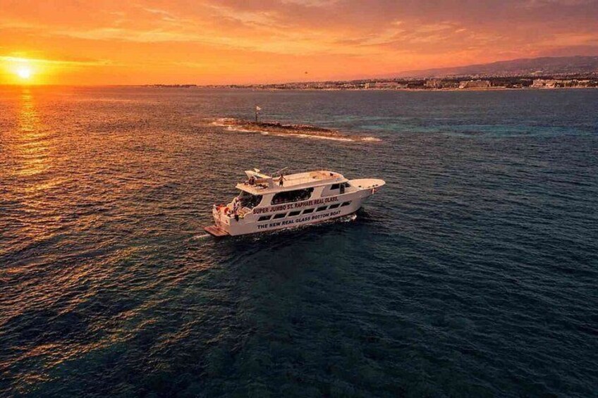 A white boat on a body of water during sunset. 1