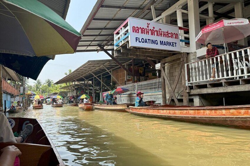 A floating market with boats and people. 2