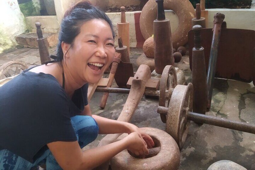 A person operating a traditional stone mill. 2