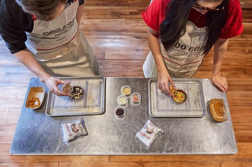 Two people preparing food at a counter with ingredients and utensils. 3