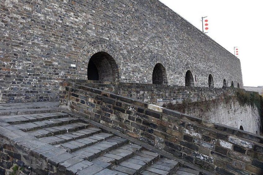 A stone staircase leading up to a large arched entrance of a historic building. 2