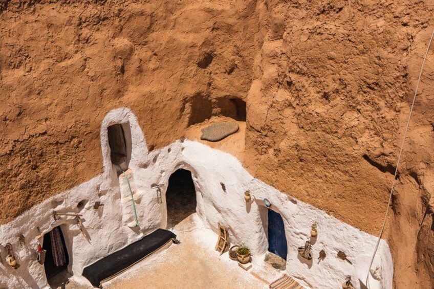 A white-roofed cave-like structure with multiple openings and a ladder. 5