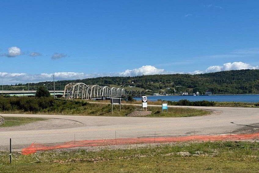 A bridge, a road sign, and a body of water. 2