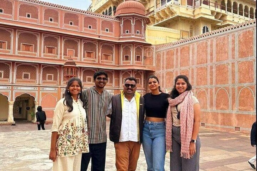A group of people standing in front of a historic building with intricate architecture. 3