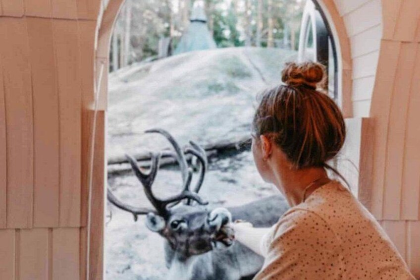 A person looking at a deer through a doorway. 3