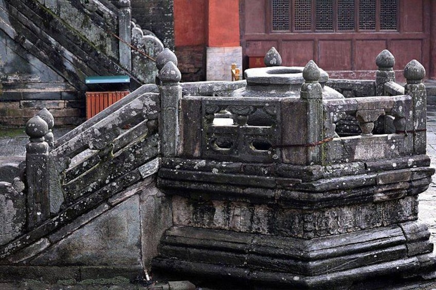 A stone bridge with ornate balustrades and a traditional architectural style. 4
