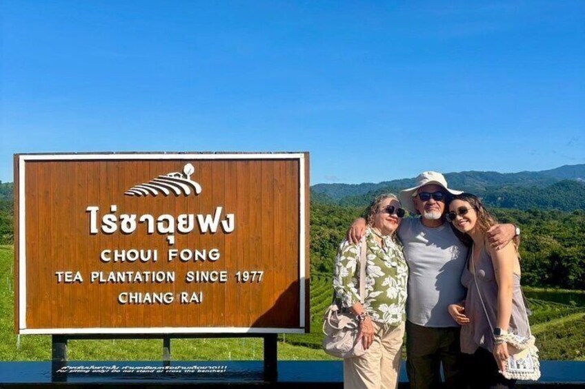 A wooden sign with the text "Choui Fong Tea Plantation Since 1977 Chiang Rai" and a logo of a tea leaf. 1