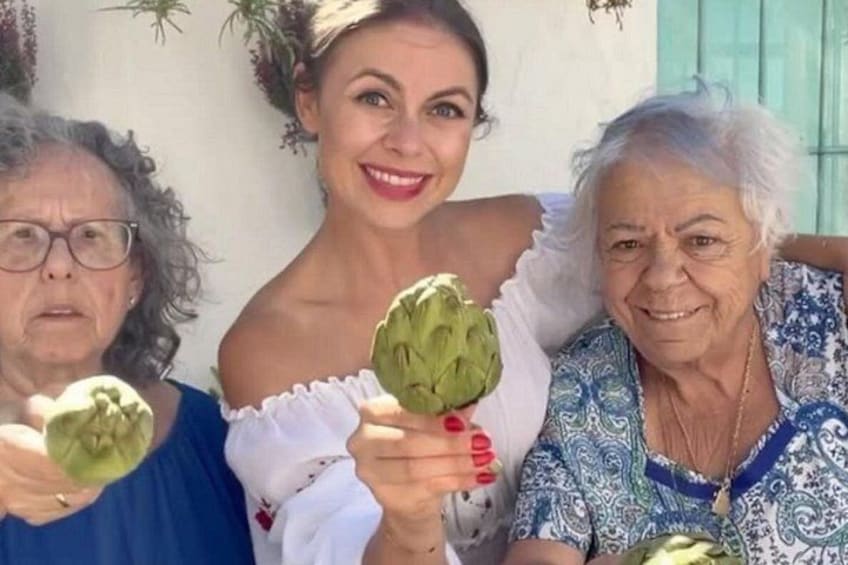 Three people holding artichokes. 3