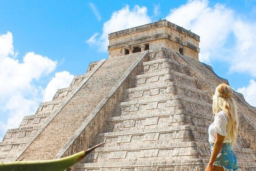 A large stone pyramid with a staircase leading to the top. 1