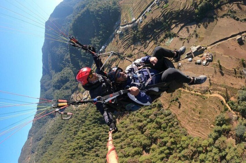 A person paragliding with a mountain landscape in the background. 5