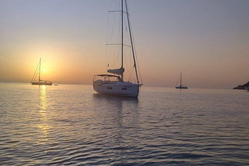 A sailboat on calm waters during sunset. 3