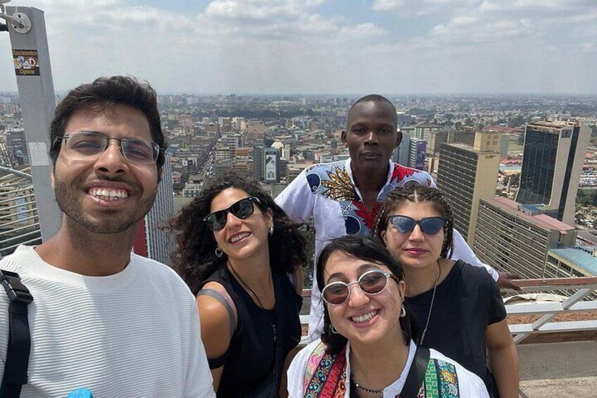 A group of people on a high vantage point overlooking a cityscape. 3