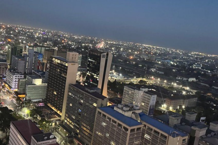 A cityscape at night with illuminated buildings and streets. 3