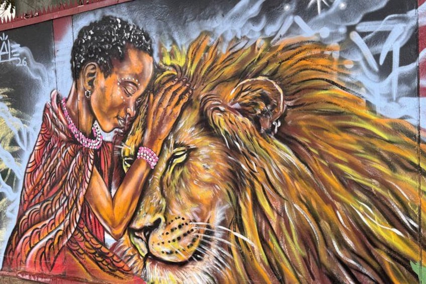 A mural with a person and a lion. 5