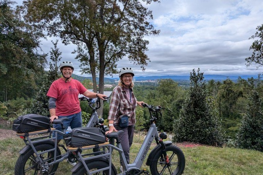 Two people with bicycles in a natural setting. 3