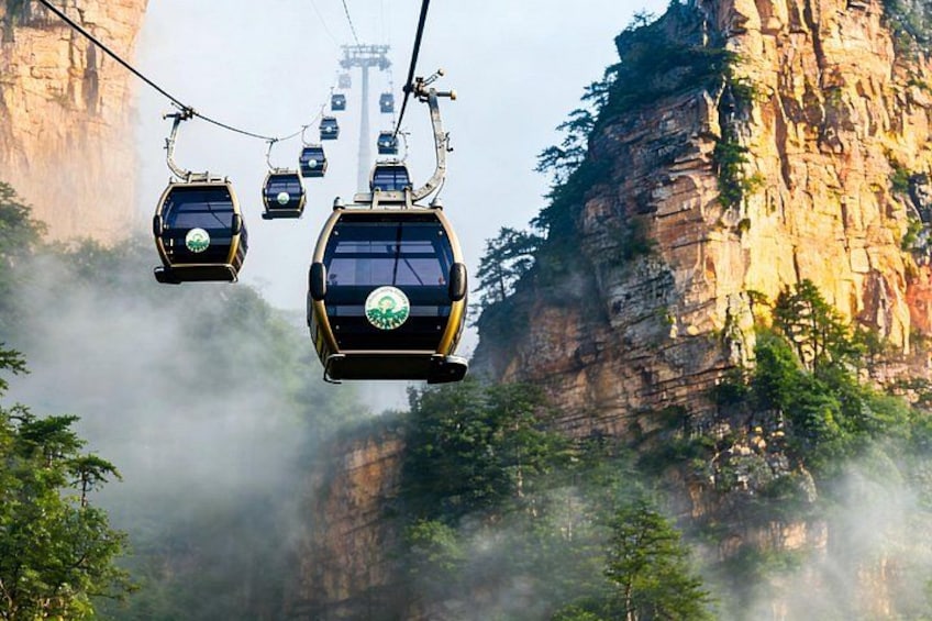 A cable car system in a mountainous area with steep cliffs and mist. 2