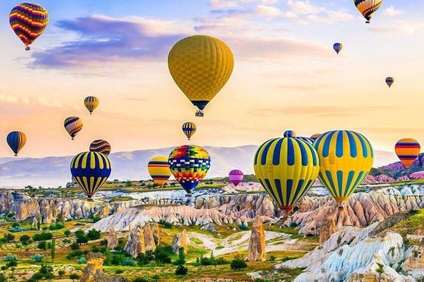 A landscape with hot air balloons and a colorful sky. 2