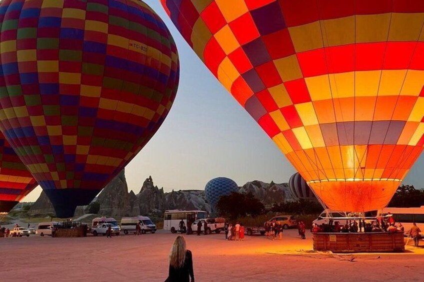 Hot air balloons, a clear sky, and a distant landscape with rocky formations. 4