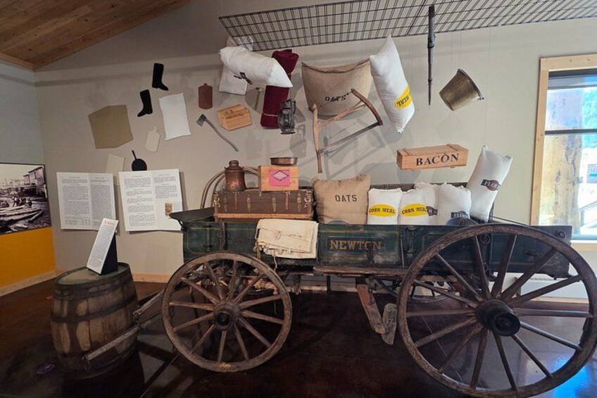 A vintage wagon with sacks labeled 'Bacon,' 'Oats,' and 'Corn Meal.' 4