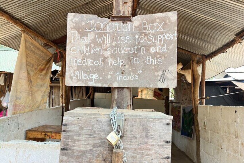 A donation box for supporting children, education, and medical help in a village. 4