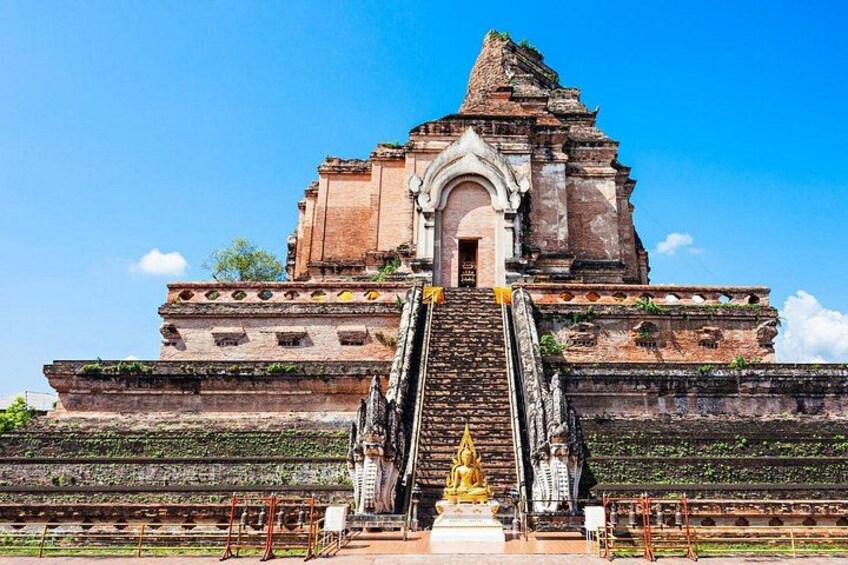A temple with a central staircase, a golden statue, and a large Buddha figure. 2