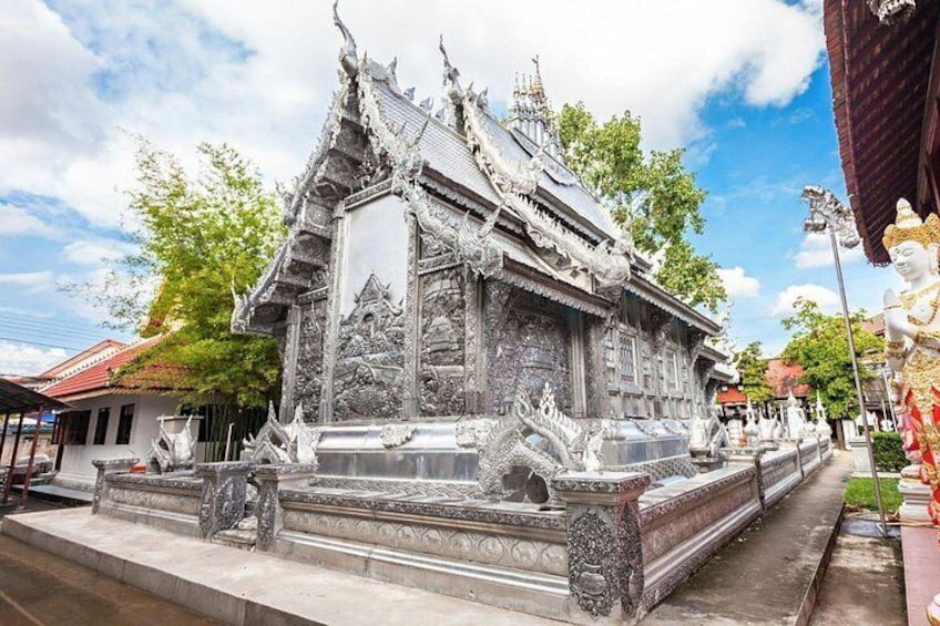 A traditional Thai temple with ornate architecture and a large statue. 2