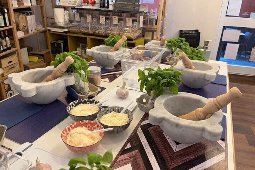 A kitchen display with stone mortars, wooden pestles, and fresh herbs. 1