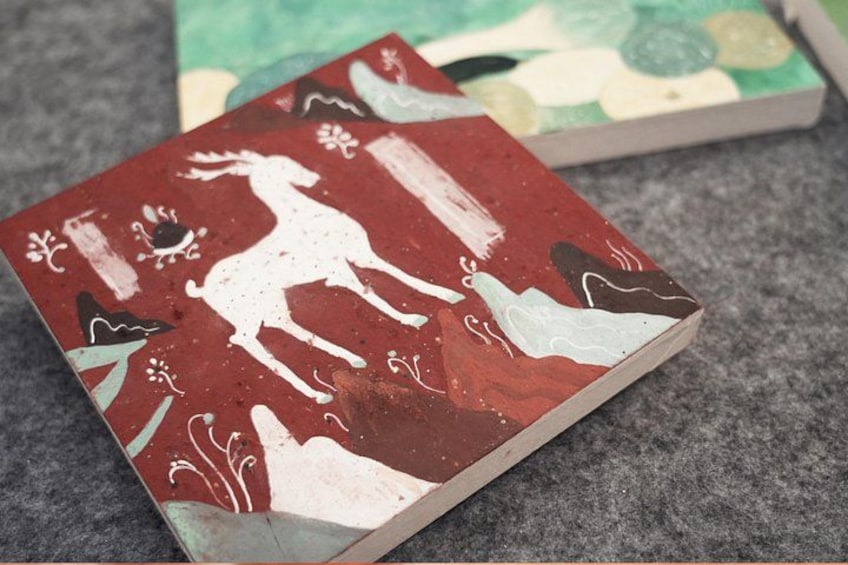 A red and white patterned box with a white silhouette of a deer. 3
