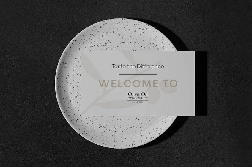 A plate with a speckled design and a card with text. 1