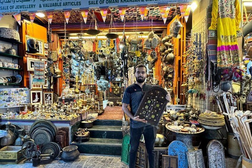 A shop filled with various items like pottery, jewelry, and textiles. 3