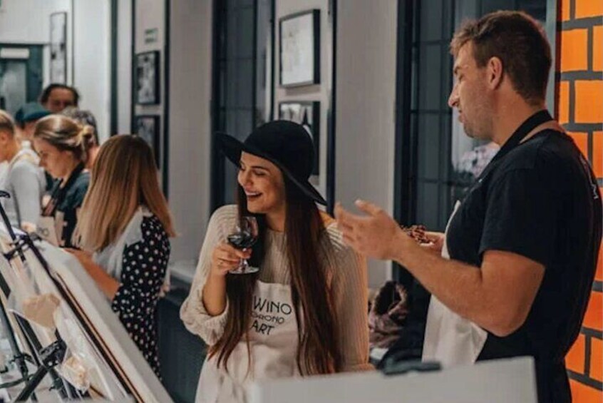 People at an indoor event, some holding glasses. 2