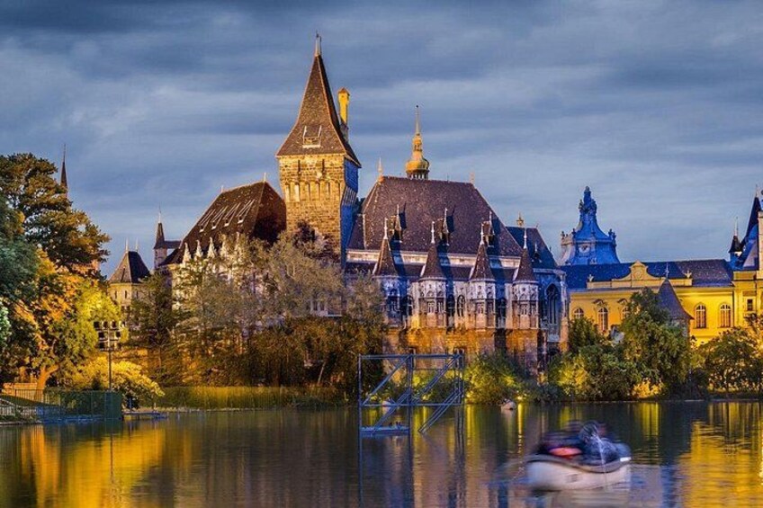 A historic building with a tower, a bridge, and a body of water reflecting the architecture. 2