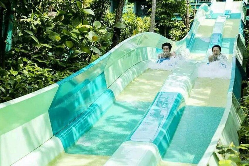 A water slide with two people sliding down. 4