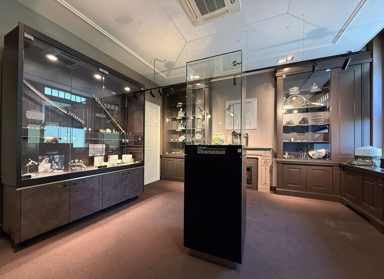 A jewelry store with glass display cases and wooden cabinets. 1