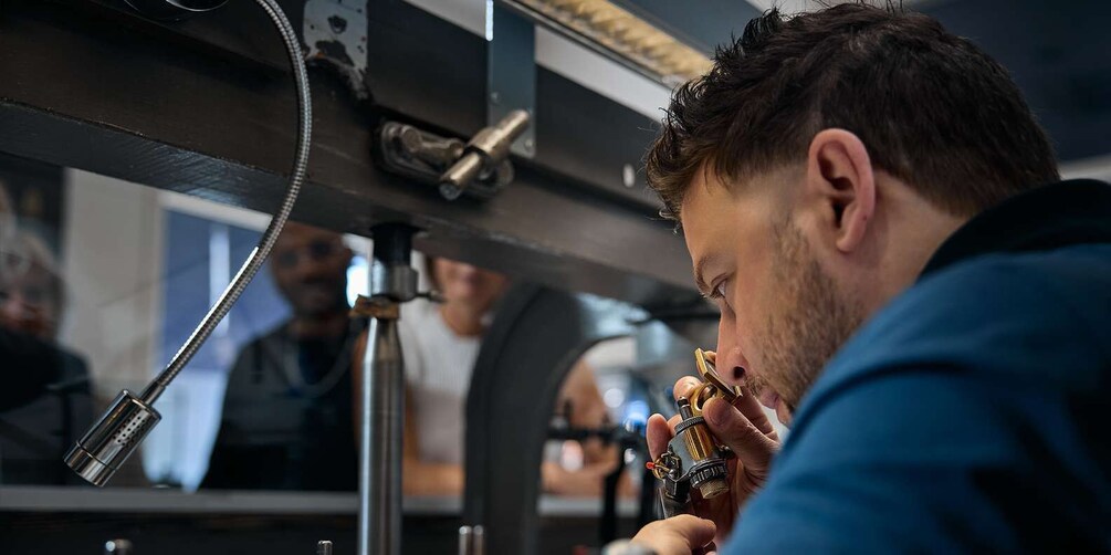 A person using a tattoo machine. 3