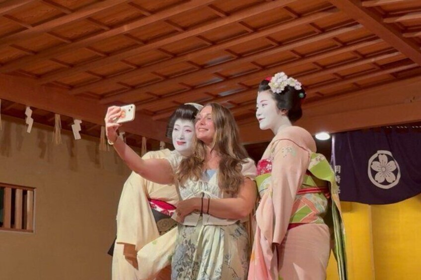 A person taking a selfie with two individuals in traditional Japanese attire. 3