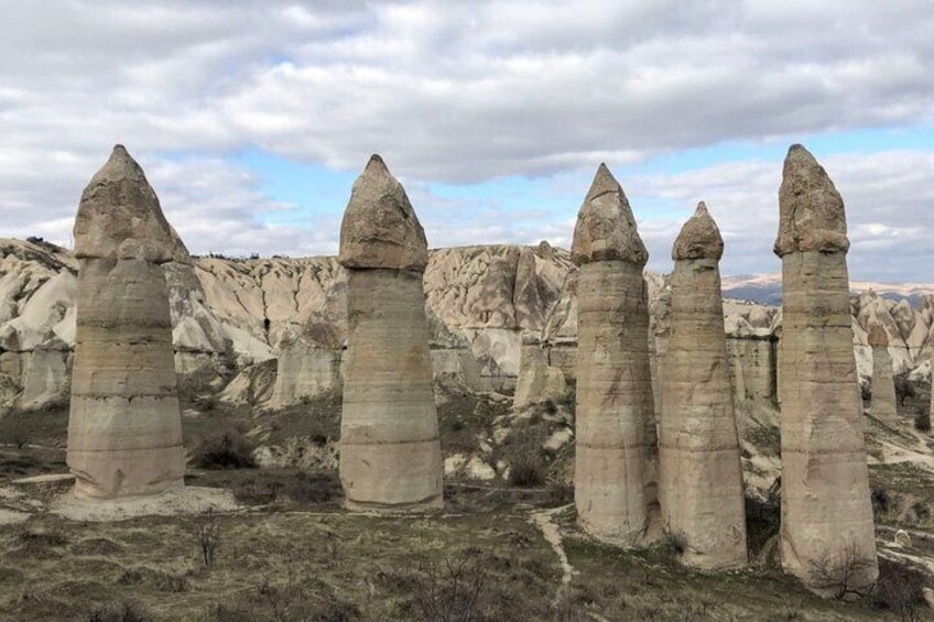 A landscape with tall, narrow rock formations. 1