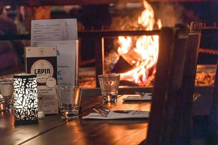 A table with glasses, a menu, and a candle. 5