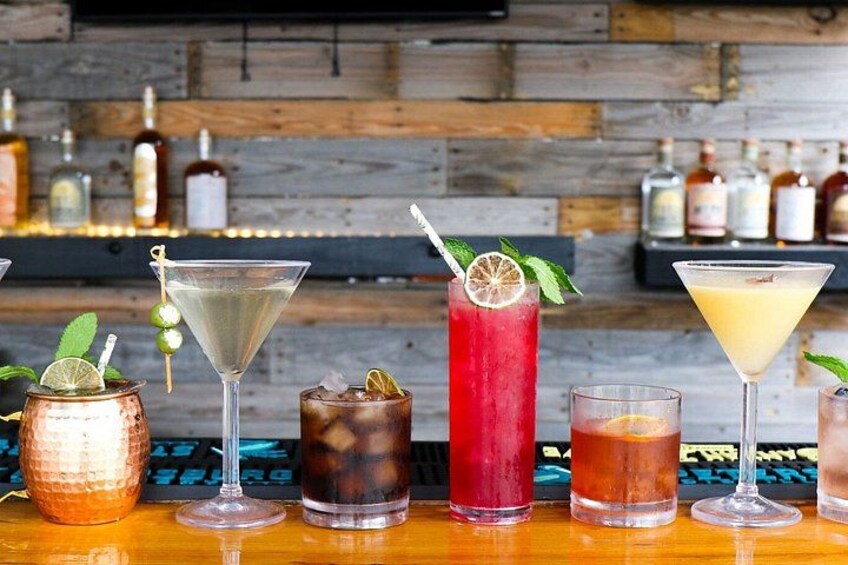 A bar with various cocktails and bottles in the background. 2