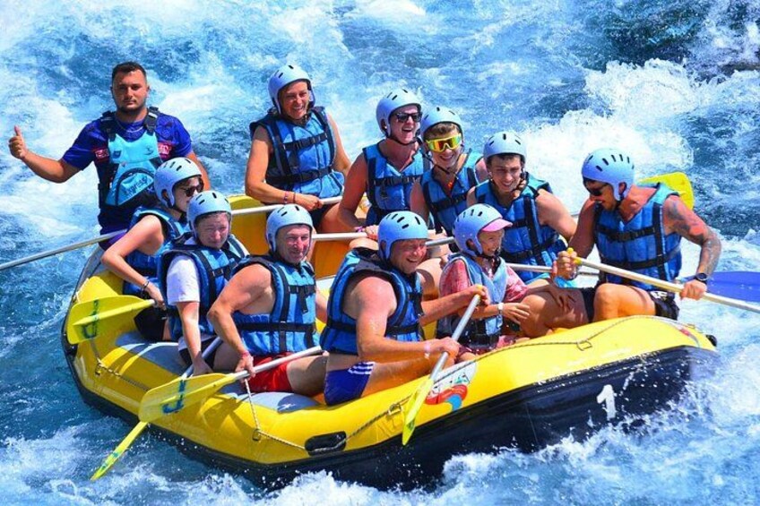 A group of people in a yellow raft navigating through white water rapids. 5