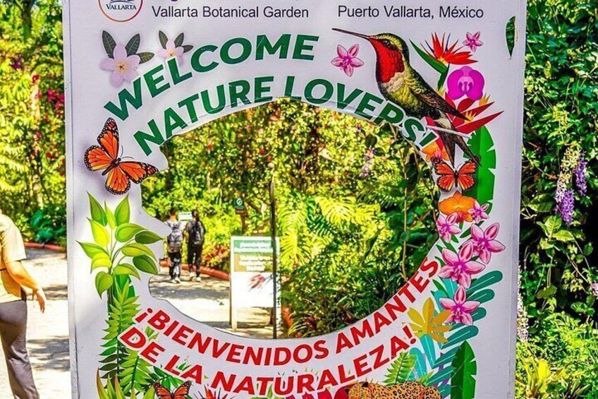A welcome sign at the Vallarta Botanical Garden in Puerto Vallarta, Mexico, featuring a circular design with butterflies and flowers. 1