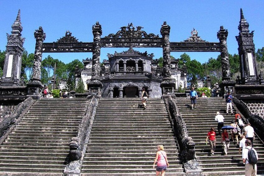 A temple entrance with ornate stone steps and a large gateway. 2