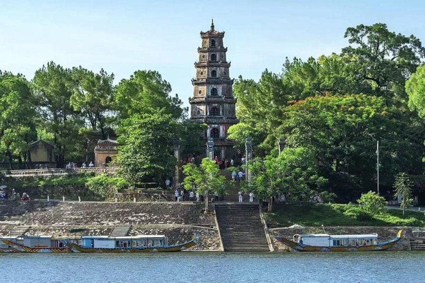A traditional pagoda, a river, and boats. 5