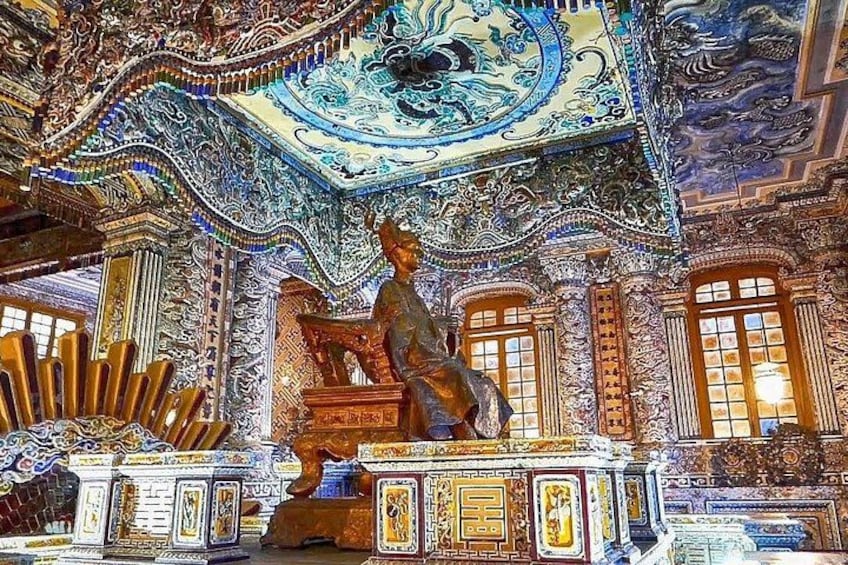 A detailed interior with ornate decorations, a statue, and a patterned ceiling. 3