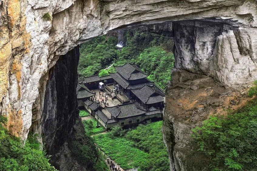 A traditional building nestled within a natural rock formation. 5