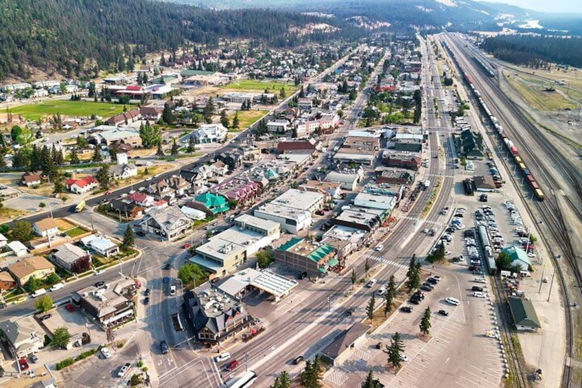 An aerial view of a town with a railway line, roads, and buildings. 2