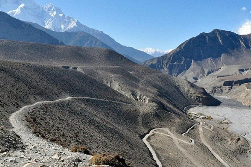 A mountainous landscape with a winding road. 4