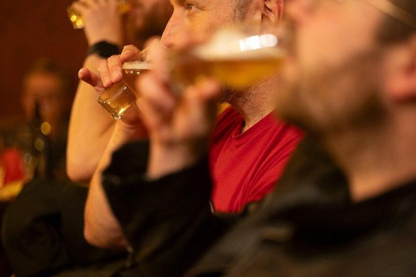 A person holding a glass of beer. 1