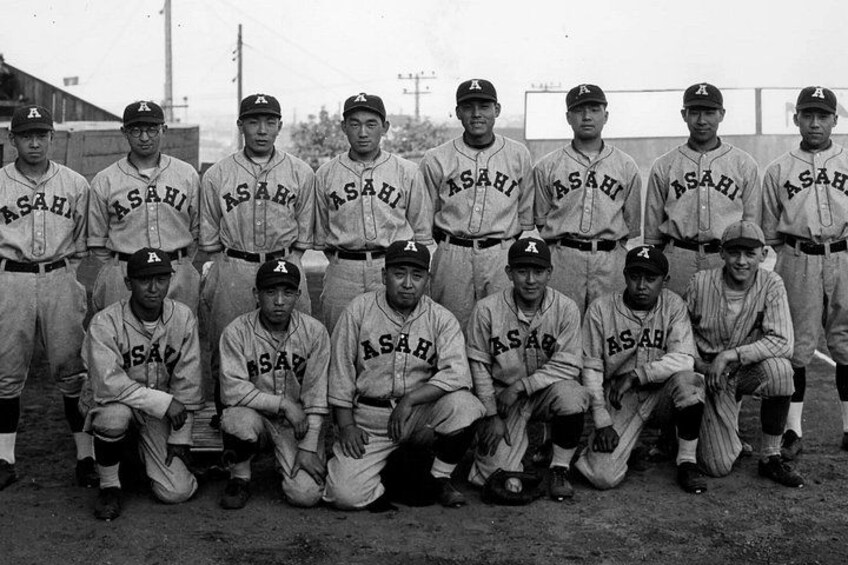 A baseball team in uniform posing for a group photo. 5